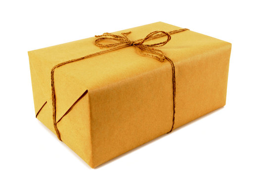One single small mail package parcel wrapped brown paper tied with string isolated on white background photo