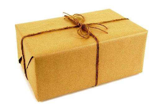 One single small mail package parcel wrapped brown paper tied with string isolated on white background photo