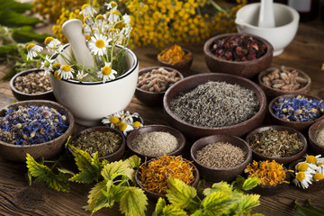 Herbs medicine and vintage wooden desk background
