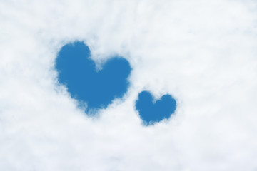 Naklejka na ściany i meble two heart shaped clouds on blue sky