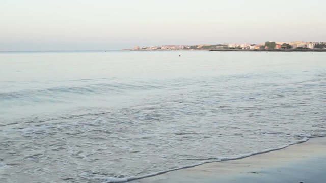 the calm blue sea waves lapping on the shoreline