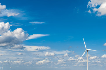 Wind turbine and blue sky background.