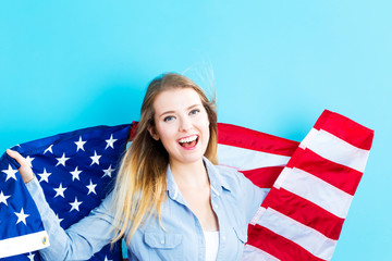 Young traveling woman holding American flag