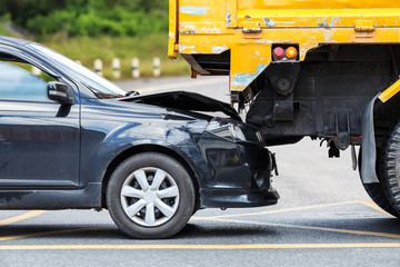 Fototapeta premium Accident on the road involving black car and yellow truck