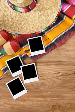 Several polaroid style phto print frame on a mexico background with sombrero and traditional serape rug or blanket mexican holiday vacation memories