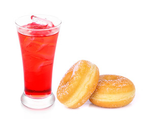 red sparkling water with ice in a glass and sugar donuts isolate