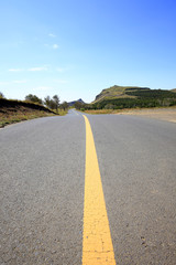 asphalt road on grassland