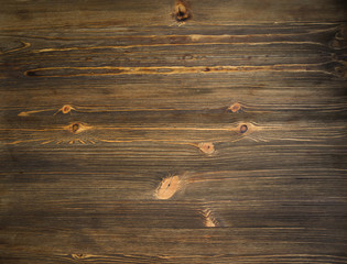 Dark brown wooden panel like a background.