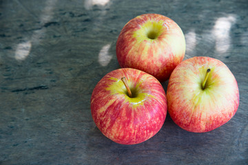 Ripe red apples on wooden background