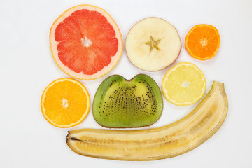 thin slicing different fruits on white background