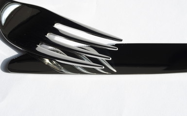 Knife and fork reflection on white background