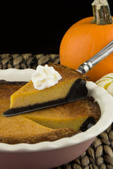 Homemade pumpkin pie with chocolate crust. Thanksgiving dinner.