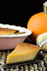 Homemade pumpkin pie with chocolate crust. Thanksgiving dinner.