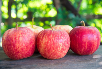 Ripe red apples on wooden background