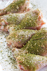 Raw meat. Ready to cook chicken legs. Skinless chicken drumsticks with herbs.