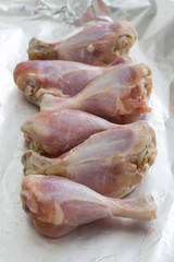 Raw meat. Ready to cook chicken legs. Skinless chicken drumsticks with herbs.