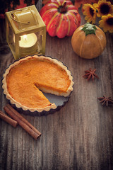 Obraz na płótnie Canvas Thanksgiving pumpkin pie on wooden background with copy space