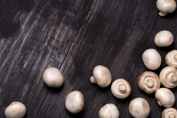 Fresh raw chestnut mushrooms on black table