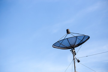 Black antenna on a sunny day with blue sky