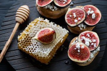 Closeup of bruschettas with fig fruits, honey and cottage cheese