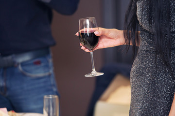 the girl holds a wine glass in hand