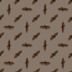 Seamless pattern with bats on brown background