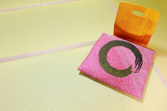 Japanese traditional wooden legless chair with Zabuton cushion on Tatami mat
