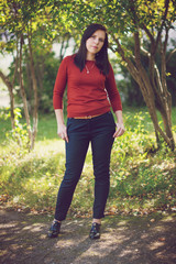 Beautiful Girl with dark hair in the autumn park