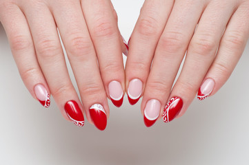 burgundy festive manicure with lace on the long sharp nails