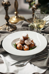 Profiteroles with whipped cream and powdered sugar