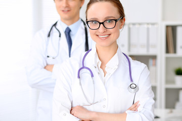 Happy doctor woman  with medical staff at the hospital