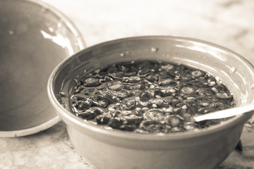 Chili and fish sauce mixed in yellow cup for seasoning thaifood with black and white theme