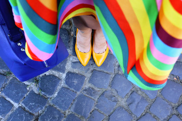 Woman legs in bright yellow leather heels