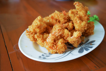 Crispy fried prawn on plate, close up