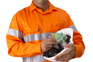 Supervisor or work man with high visibility shirt  holding and countind australian dollar as wages or reward