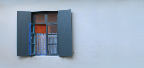 With open window shutters on the farmhouse.