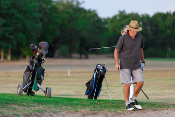Couple Enjoying A Game Of Golf