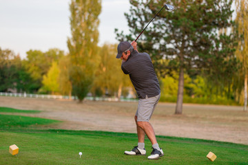 senior playing golf