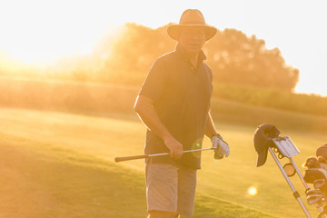 Golfer portrait on sunset with flare