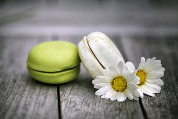 Macarons with Daisy Flowers on rustic wooden Table