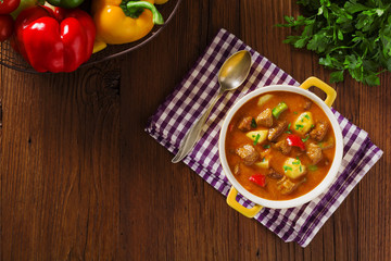 Beef stew served with cooked potatoes.