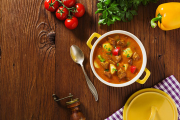 Beef stew served with cooked potatoes.