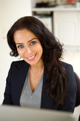 Smiling business woman sitting in office