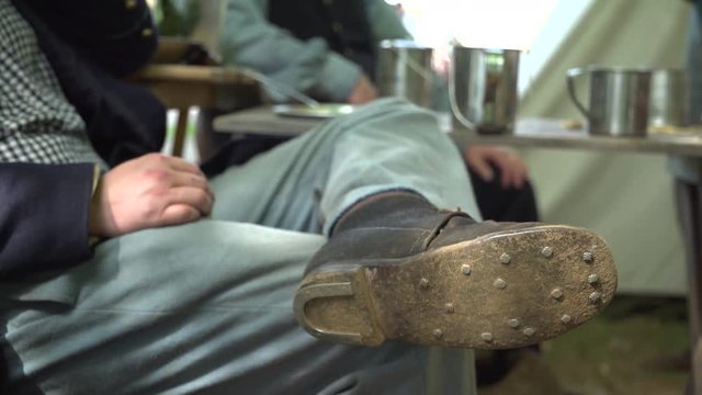 Civil War soldier reclines wearing old shoes