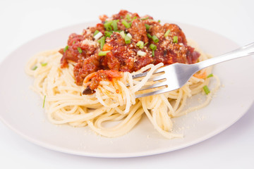Spaghetti bolognese being eaten with a fork
