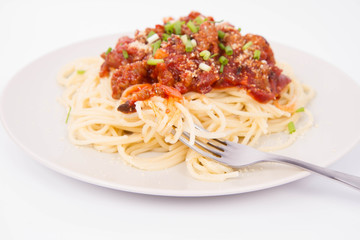 Spaghetti bolognese being eaten with a fork