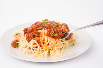 Spaghetti bolognese being eaten with a fork