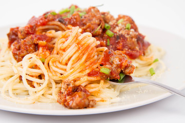 Spaghetti bolognese being eaten with a fork