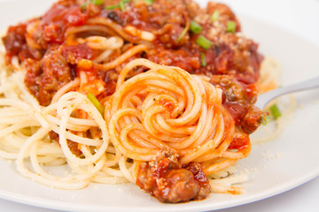 Spaghetti bolognese being eaten with a fork