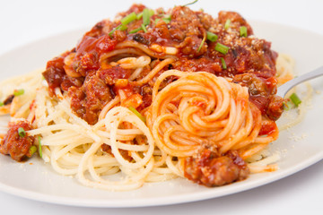 Spaghetti bolognese being eaten with a fork